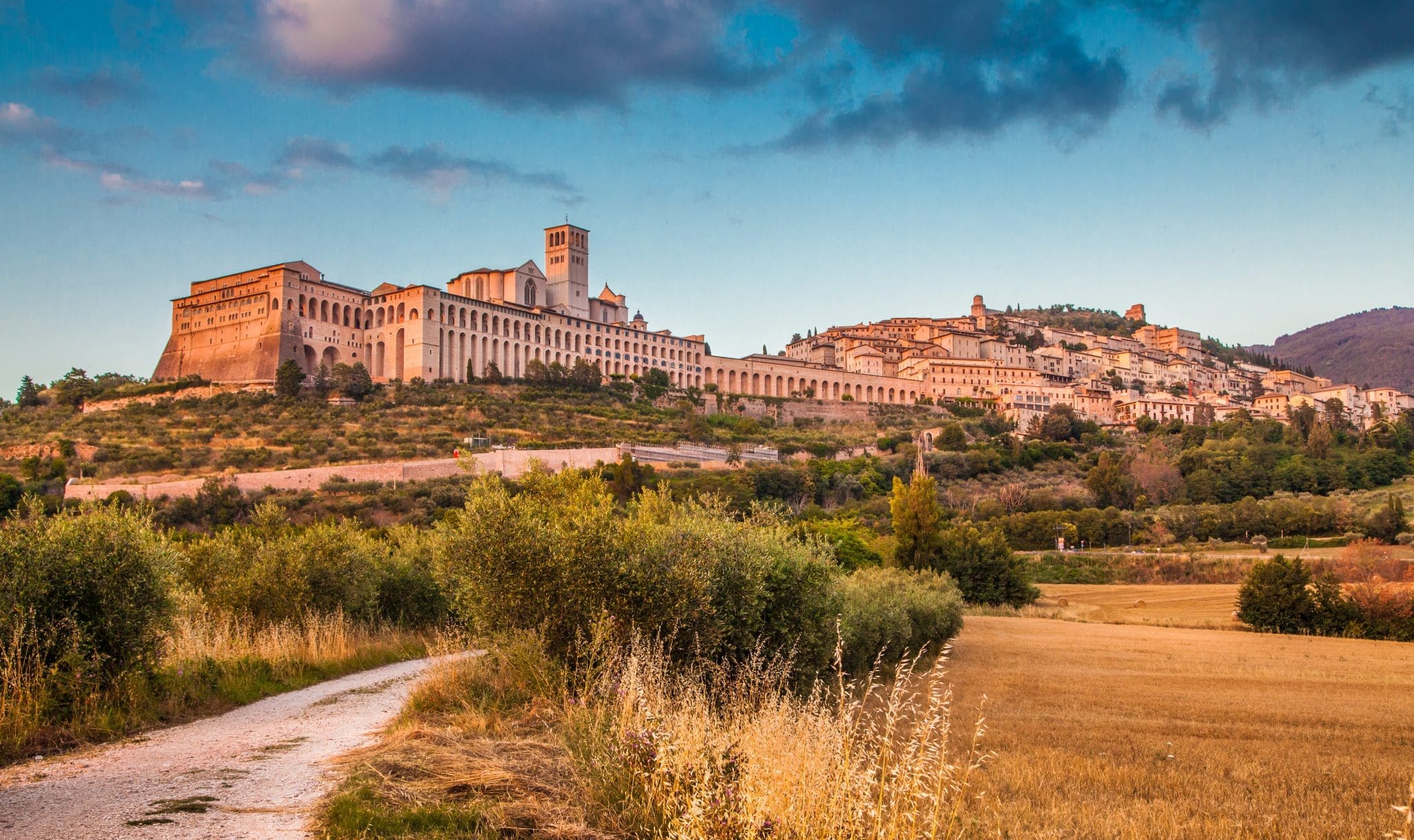 The Basilica of St. Francis and the town of Assisi at sunset