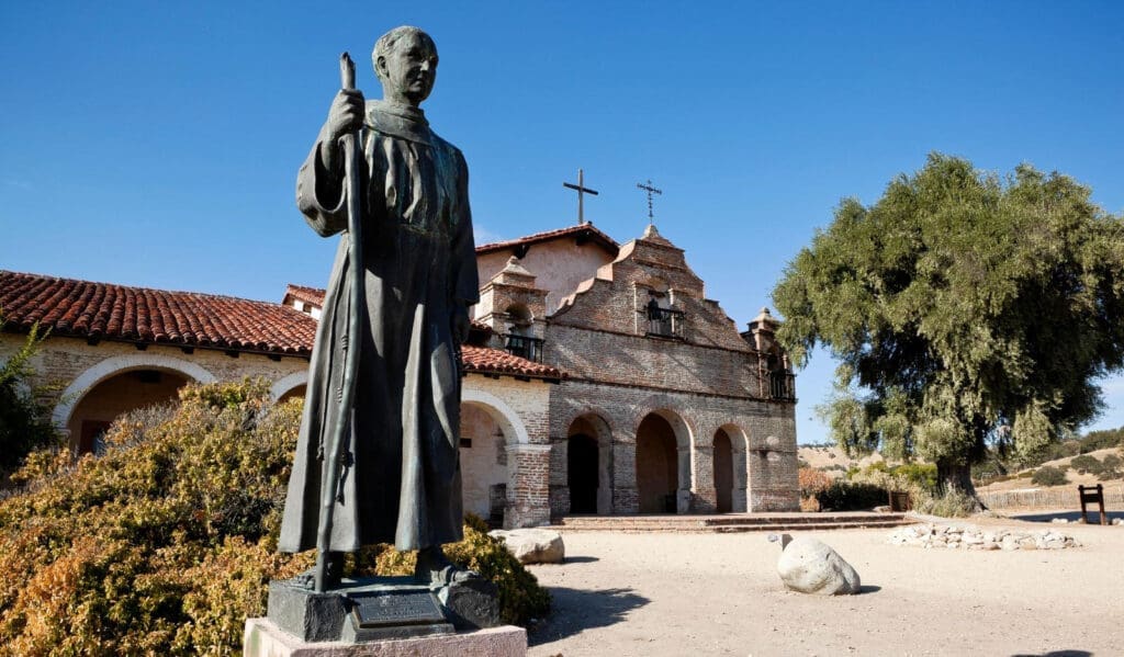The statue of St. Junipero Serra before a California mission