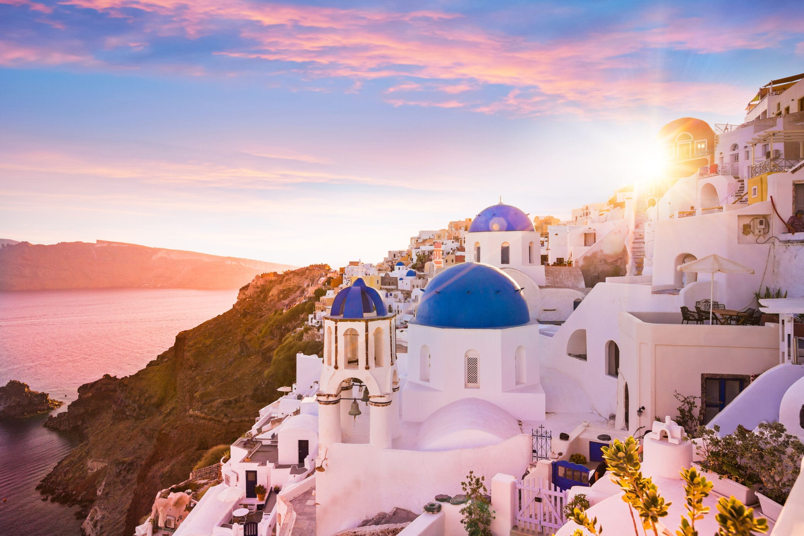 Sunset light over the blue-domed churches of Santorini, Greece