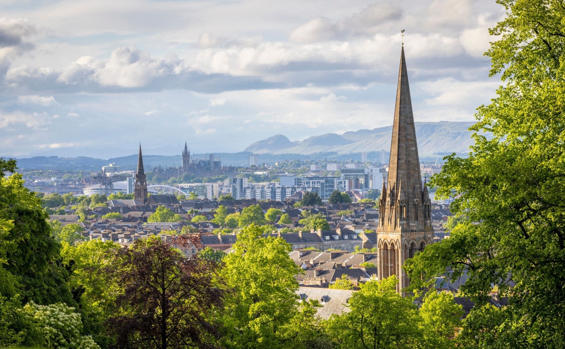 The skyline of Glasgow seen across the trees of Queens Park