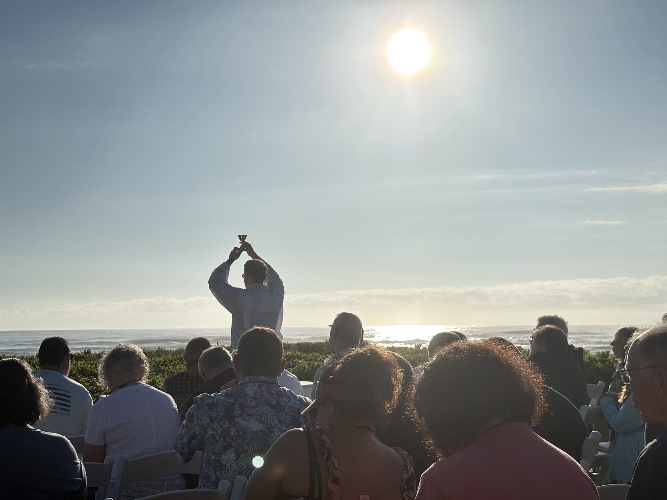 A Canterbury pilgrimage group at an outdoor Mass at sunrise