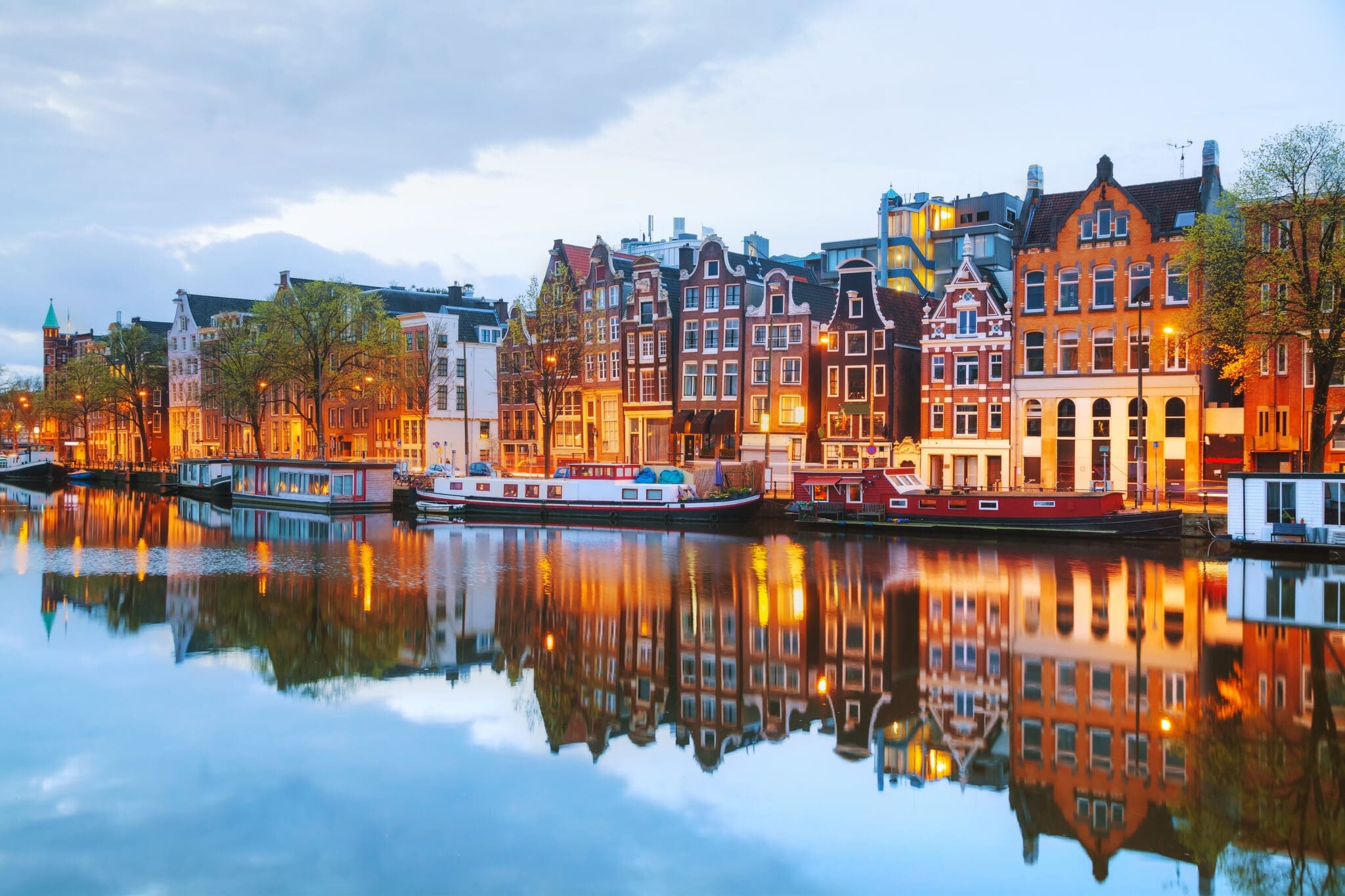 Canal houses reflected in the water at dusk, Amsterdam