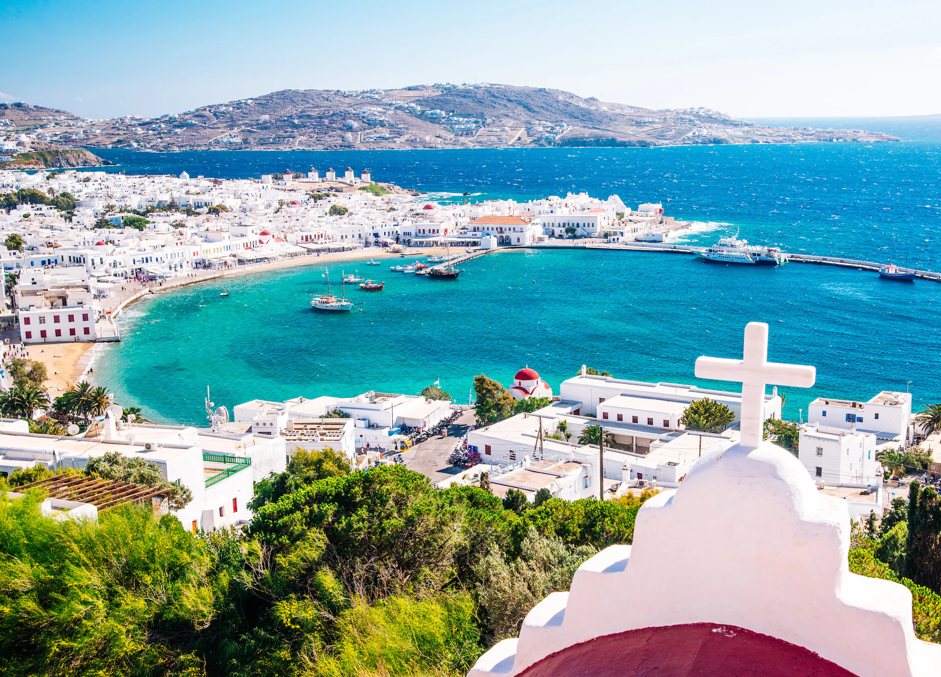 Whitewashed houses and fishing boats along the harbour at Mykonos, Greece